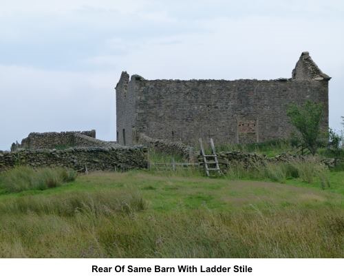 Ruined barn and ladder stile