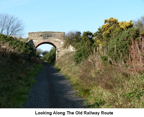 Looking along the old railway route and road bridge.