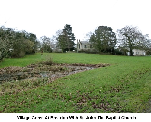 The village green at Brearton with St John the Baptist church.