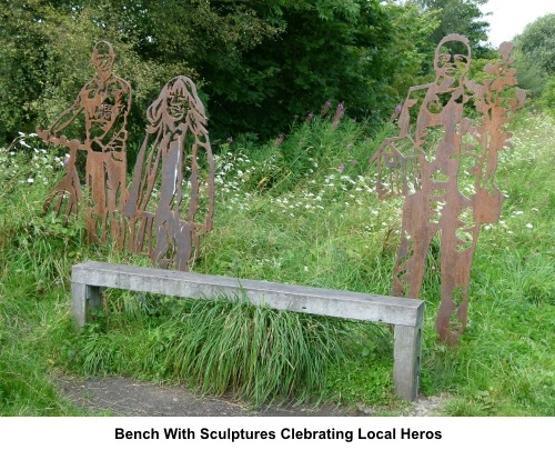 Bench with sculptures commemorating local heros