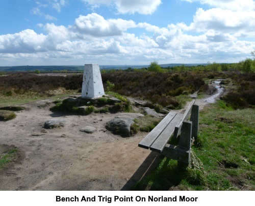 The trig. point and a bench at the summit of Norland Moor