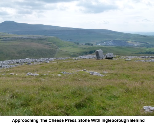 Approaching the Cheese Press Stone with Ingleborough behind.