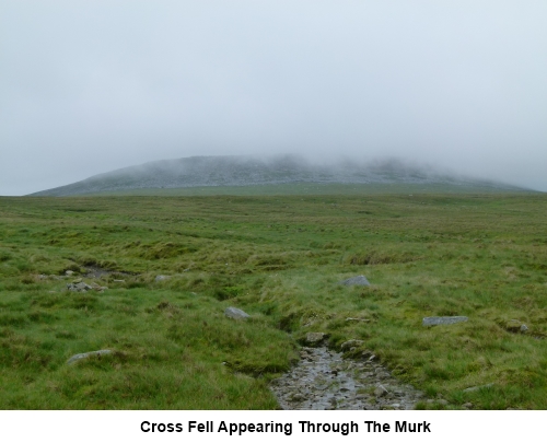 Cross Fell appearing through the murk