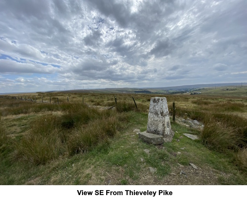 Trig. point and view SE at Thieveley Pike.