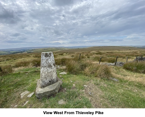 Trig. point and view west from Thieveley Pike.
