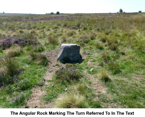 The angular rock referred to in the text marking the turn to the road.