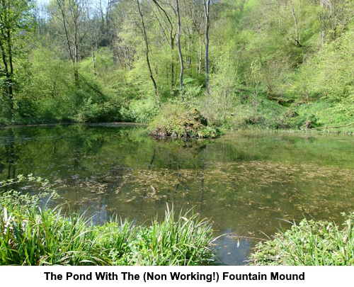 The pond with its non-working fountail which should spout from the mound in the centre.