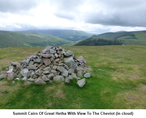 Summit carin of Great Hetha with the view to The Cheviot.