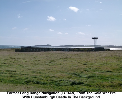 The low building which is the former Lomg Range Navigation (LORAN) from the Cold War era with Dunstanburgh Castle in the background.