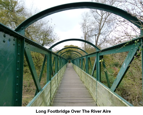 A long footbridge over the River Aire.